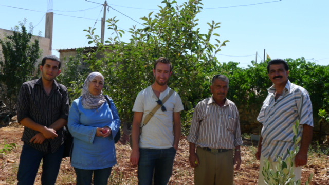 Drew Craig stands with Defence for Children International–Palestine Section lawyers (left) and two members of Iraq Burin’s village council (right), a village in the north of the West Bank