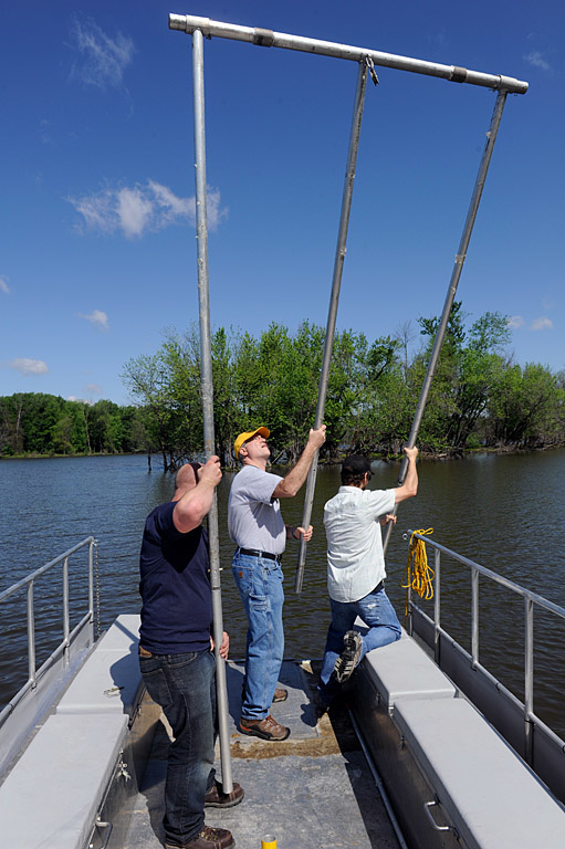 Brad Reuter, Doug Schnoebelen, and Andres Martinez set up the core sampling rigging on their research boat.