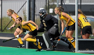 field hockey players in front of goal