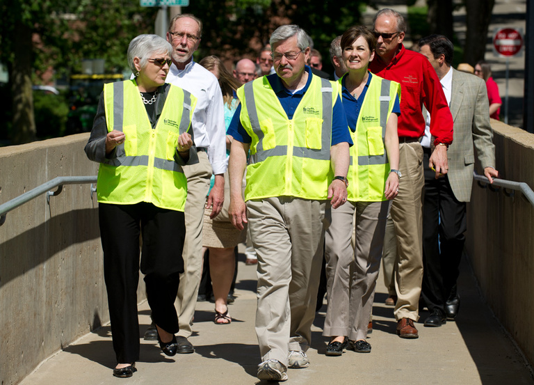 UI President Sally Mason leads dignitaries on a tour of flood preparations.