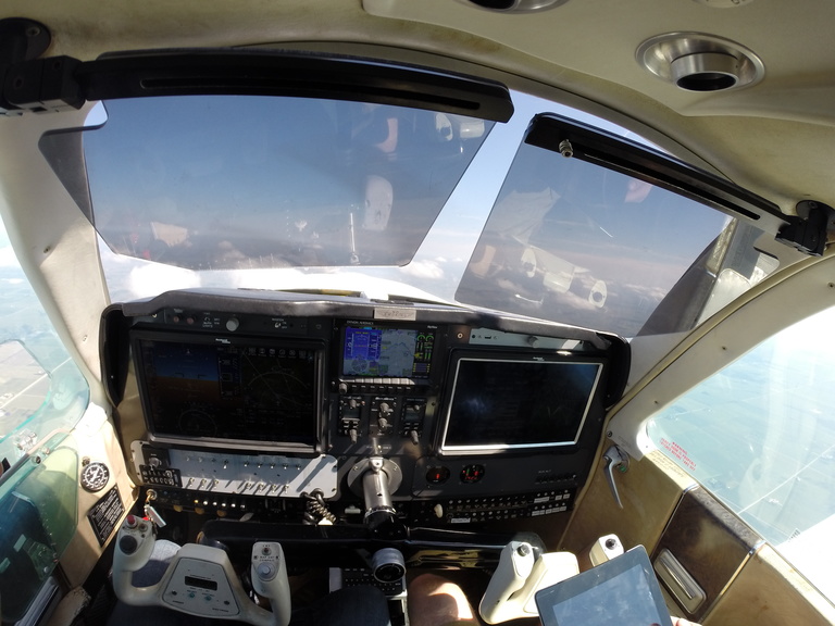 Photo shows the interior of an Operator Performance Laboratory (OPL) experimental aircraft, with safety pilot on board, while being remotely piloted.