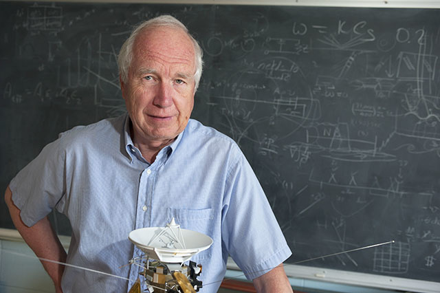 Don Gurnett in classroom with spacecraft model