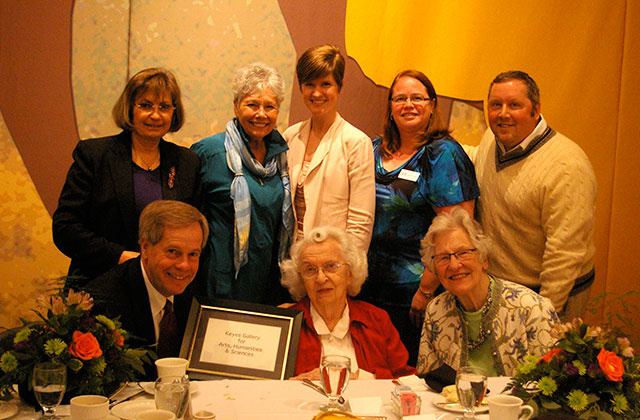 Margaret Keyes in a group photo with award certificate