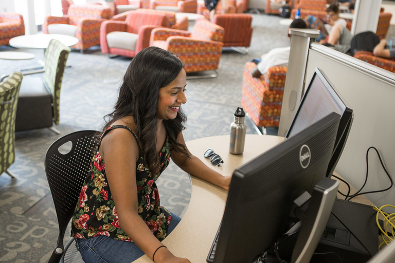Color photo of a student seated at a computer terminal at the Learning Commons