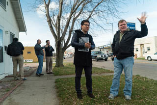 Ron Beals and Xiochen Hu talk while standing in a residential area