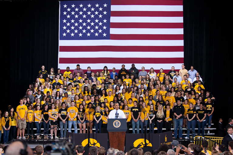 obama speaks with UI students and u.s. flag in the background