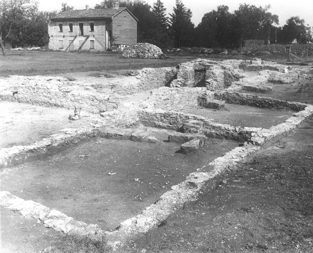 Luther College professor Sigurd Reque’s 1940 archaeological excavations at Fort Atkinson, which here exposed the officer’s quarters foundation. Standing building is the north barracks.