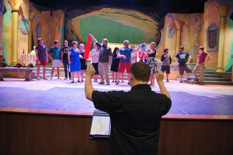 David Tedford conducts as students from the University of Iowa School of Music rehearse their roles for their performance of Gilbert & Sullivan's "The Gondoliers" on Tuesday, June 30th. The comedic opera is being directed by Nicholas Wuehrmann and will pe