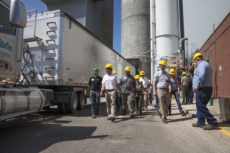 People in hard hats next to a semi truck at the UI power plant