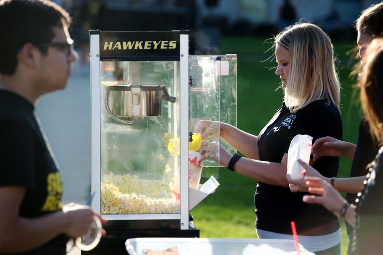 Univeristy of Iowa students, faculty and fans enjoy popcorn during the Beat State Pep Rally. 