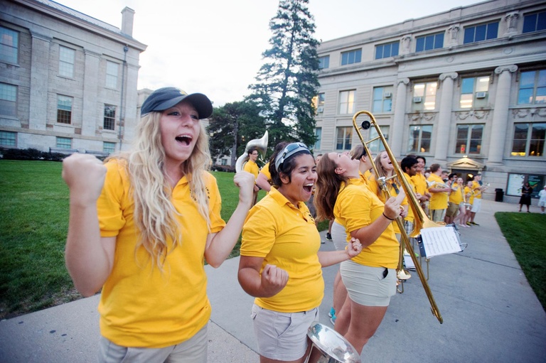 Members of the University of Iowa Marching Band join the crowd in a cheer during the Beat State Pep Rally.