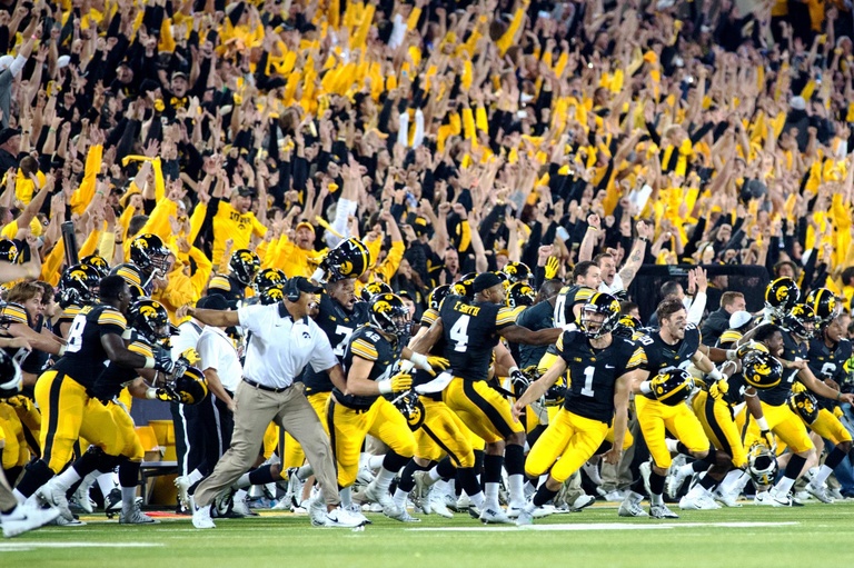 Team and fans celebrating win at Kinnick