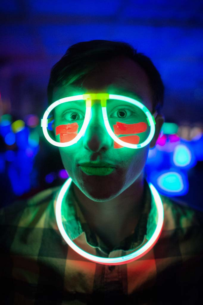 Man wearing glow stick glasses and necklace