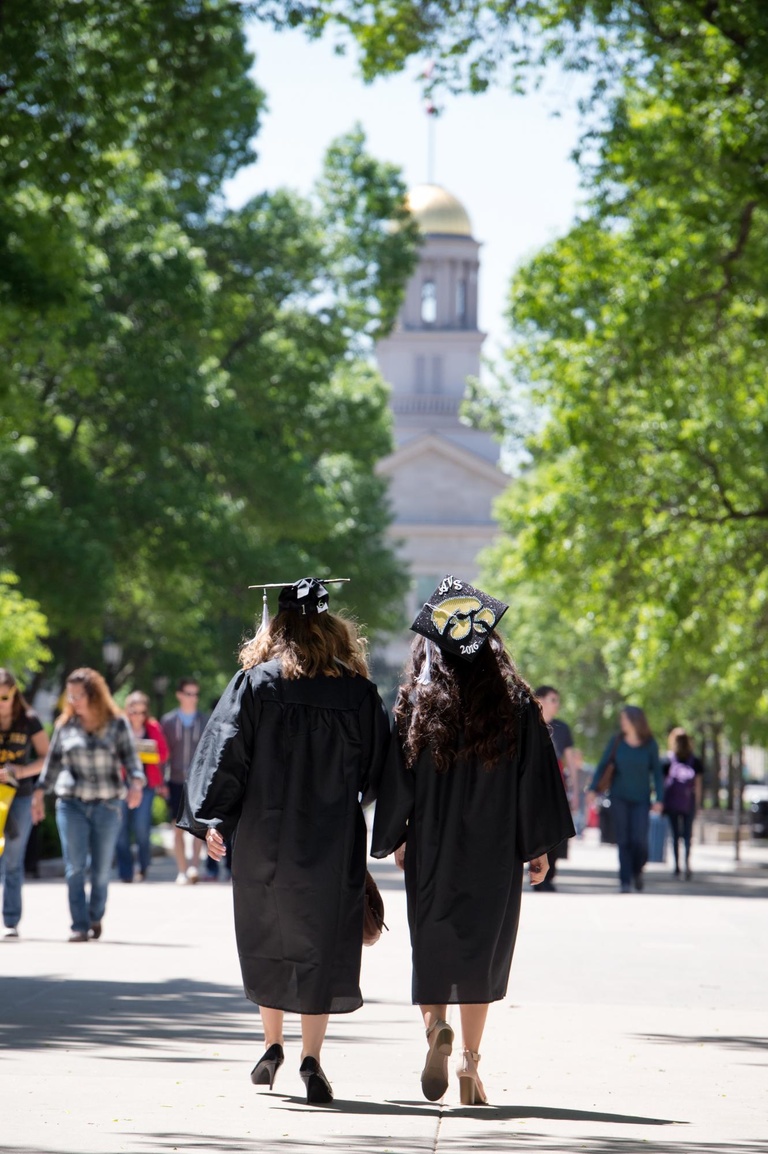 graduates walking toward old cap