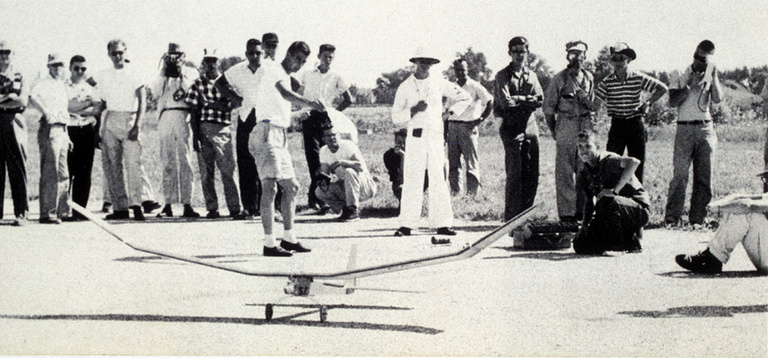 A model designed and built by Don Gurnett, kneeling, in 1957 competes in the Pan American World Airway event for lifting the most weight in flight. He won the event.