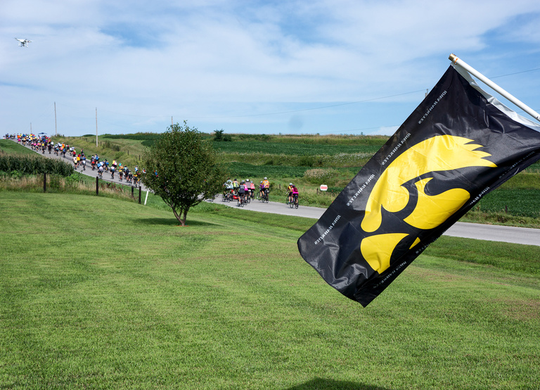 tiger hawk flag flying with cyclists in background