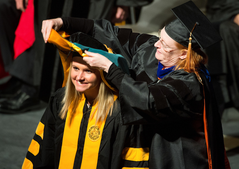 A student receives her degree at the Graduate College commencement ceremony on Dec. 16. About 250 students received their degrees at the ceremony.