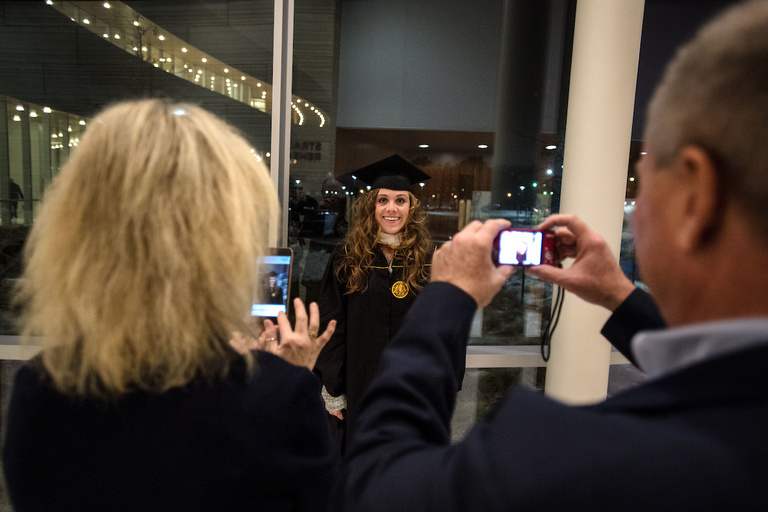 A student poses for a photo before the UI Graduate College commencement ceremony on Dec. 16. About 250 students received degrees at the ceremony.
