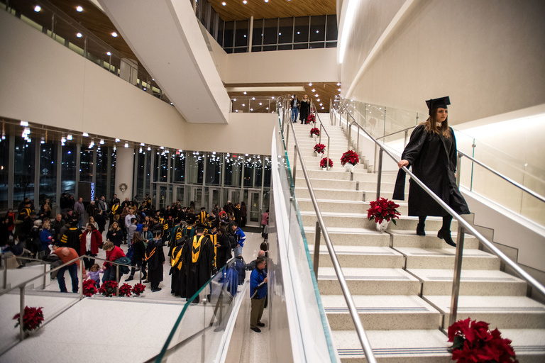 A student makes her way down the stairs at Hancher Auditorium before the University of Iowa Graduate College ceremony on Dec. 16. About 250 students received degrees at the ceremony.