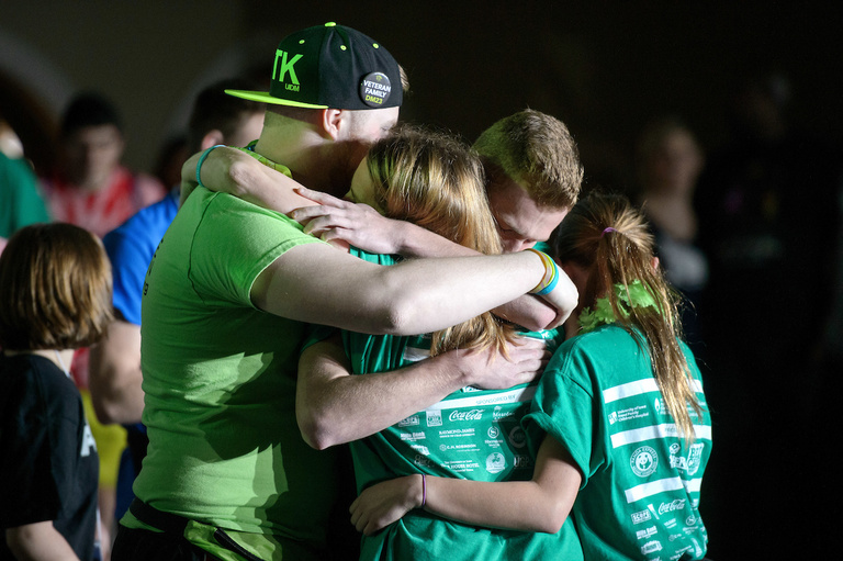 a family embraces at dance marathon 23