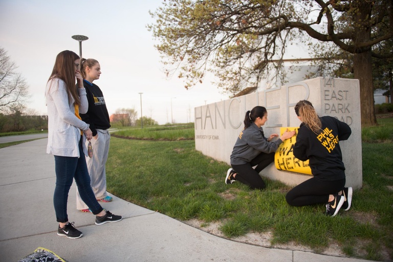 Members of the University of Iowa Foundation’s Student Philanthropy Group affixed a “Phil Was Here” label to Hancher’s sign, indicating that philanthropy has made a difference there.