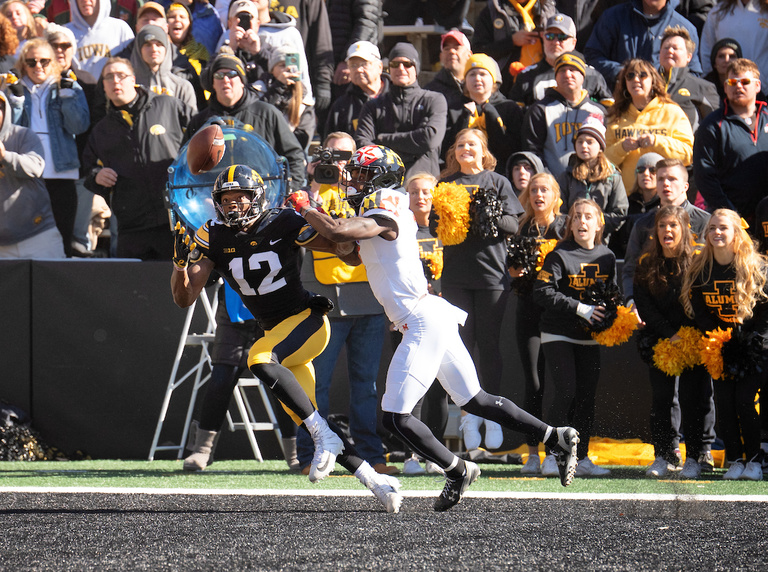 iowa football player reaching out for a pass in the end zone