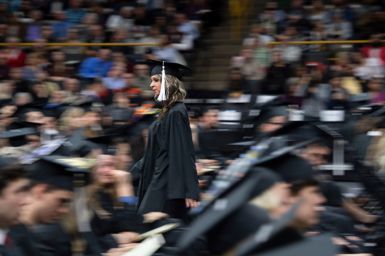 grad highlighted against blurred commencement