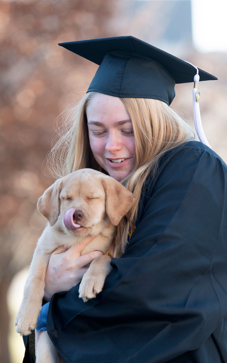 grad with puppy