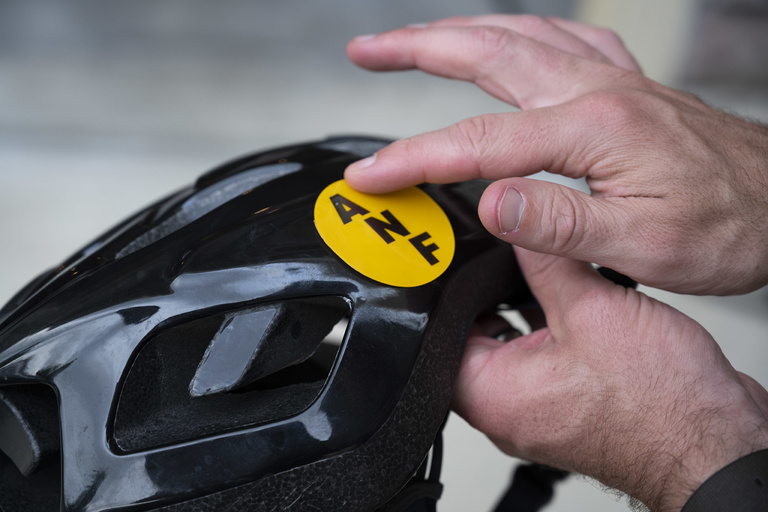 rider affixes america needs farmers sticker to helmet