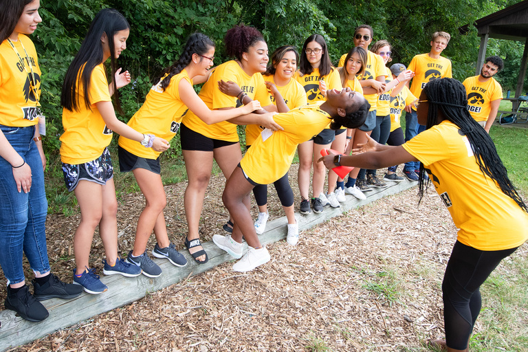 students balance on log in iowa edge team-building exercise