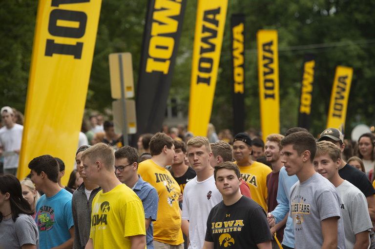 new students file past iowa banners during convocation and block party 2019