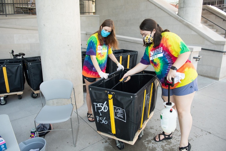 volunteers sanitize carts
