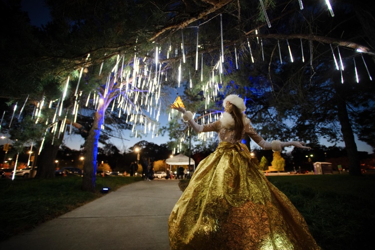 performer under illuminated tree
