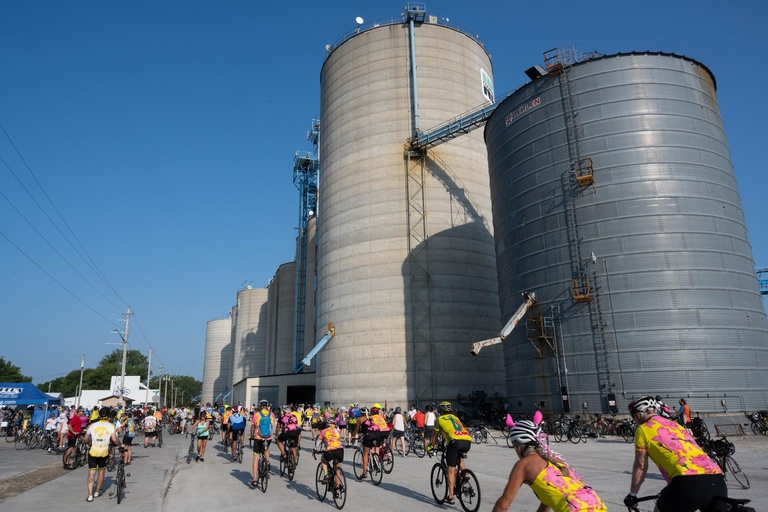 riders passing below grain silos