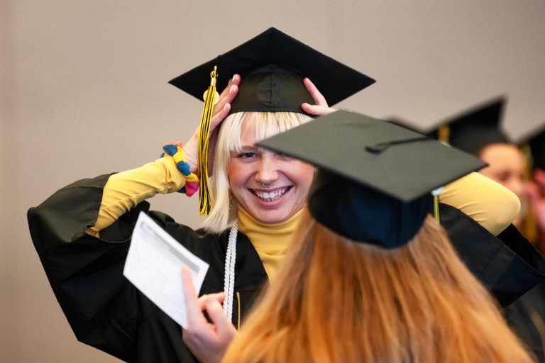 A College of Education graduate prepares for their commencement ceremony. Photo by Justin Torner.