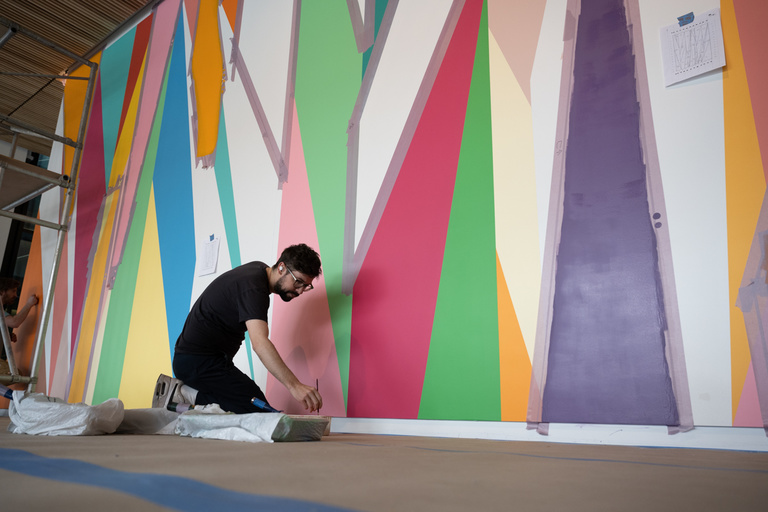 Alan Prazniak paints a section of the mural "Surrounding" inside the UI Stanley Museum of Art. 