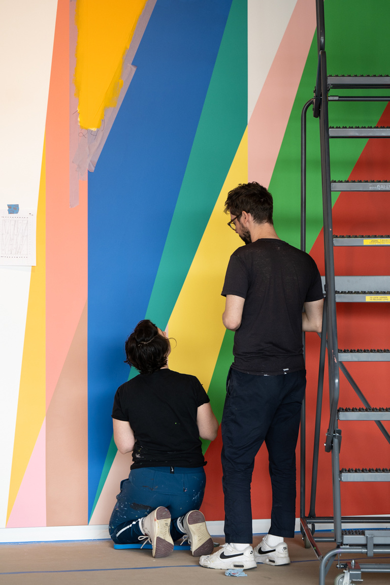 Painters Jenna Pirello and Alan Prazniak discuss what is next after completing a section of the mural inside the UI Stanley Museum of Art.