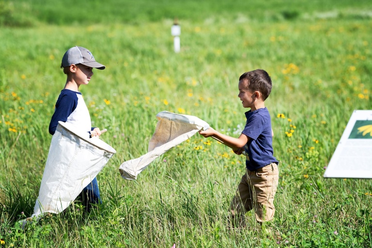 A couple young researchers discuss their findings at the Ashton Prairie Living Laboratory.
