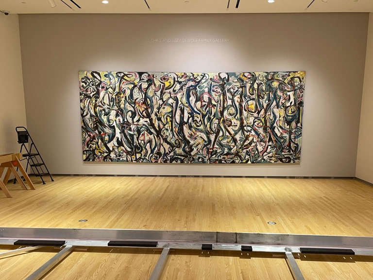 "Mural" is installed on the wall. The empty travel frame lies in the foreground.
