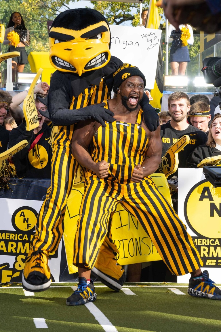 Herky jumps on the back of Ettore "Big E" Ewen. Ewen is a former Hawkeye football player who is now a professional wrestler with WWE.