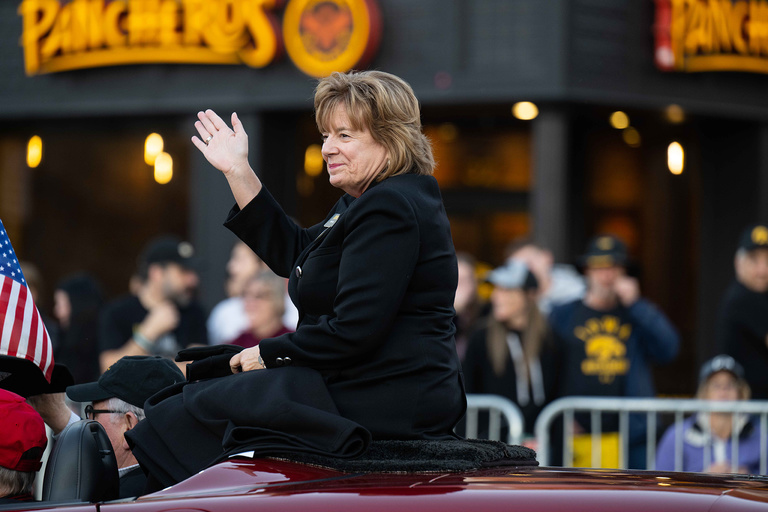 UI President Barbara Wilson takes in the sights and sounds during the UI Homecoming Parade on Oct. 28.