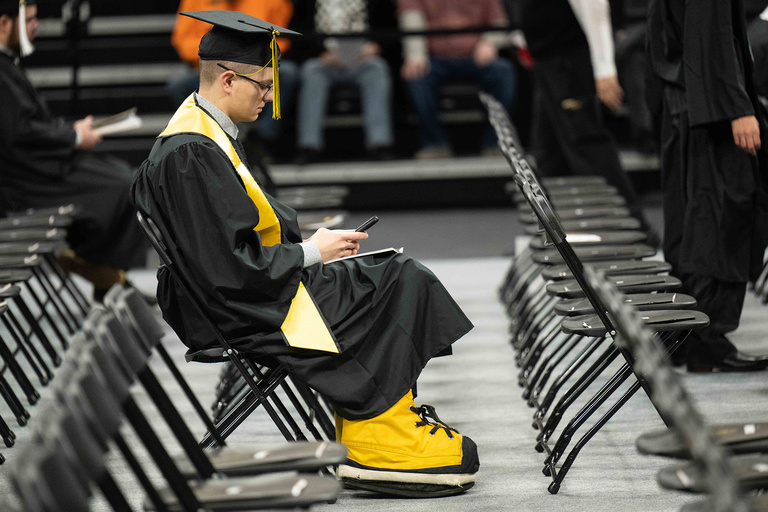 Wearing Herky's shoes, this graduate is ready to cross the stage during the College of Liberal Arts and Sciences commencement ceremony.