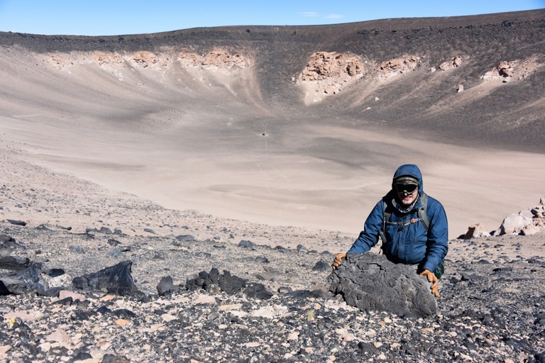 Brennan van Alderwerelt posing with a volcanic rock. 