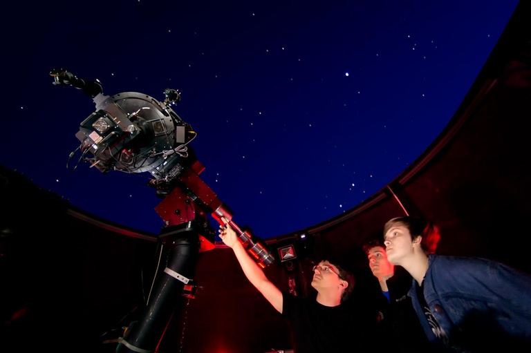 People looking through telescope