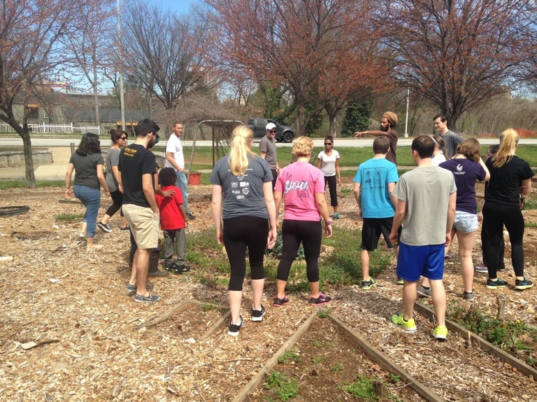 Students help with an urban garden in a park.