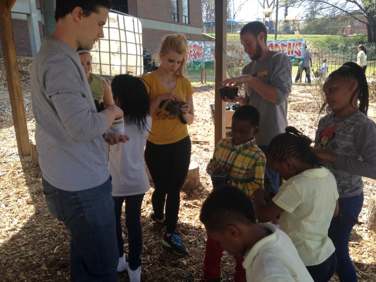 A group of students work on an urban garden.