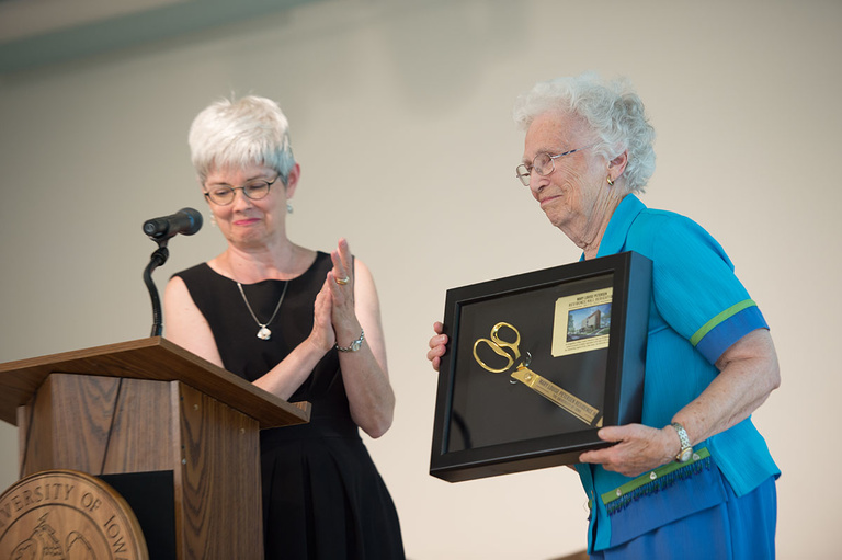 UI Foundation President Lynette Marshall presents Mary Louise Petersen with a framed memento during yesterday's dedication.