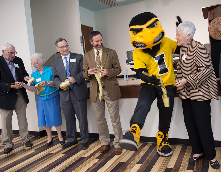 Sally Mason cuts the ribbon of the newly-dedicated Mary Louise Petersen Residence Hall.