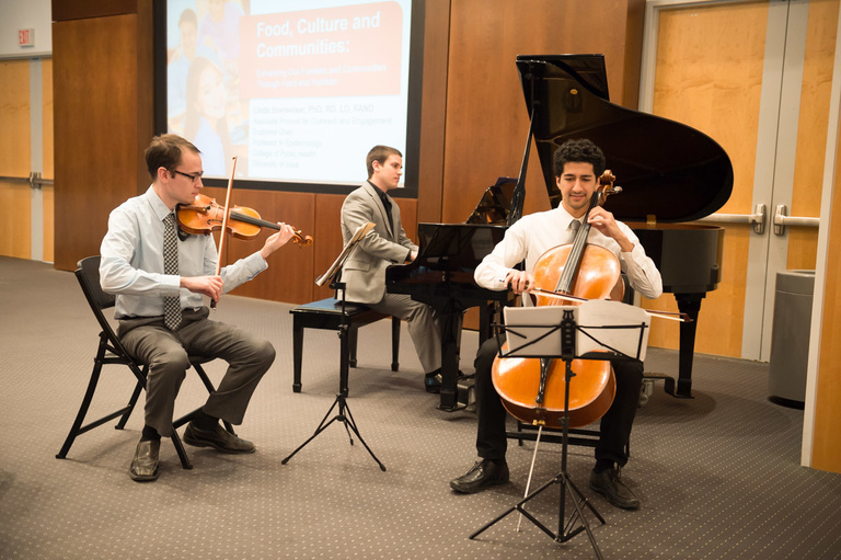 Musicians perform before the lecture begins.