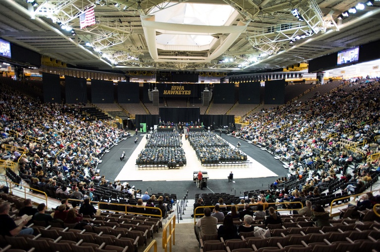 an overview shot of graduates, family, and friends in arena